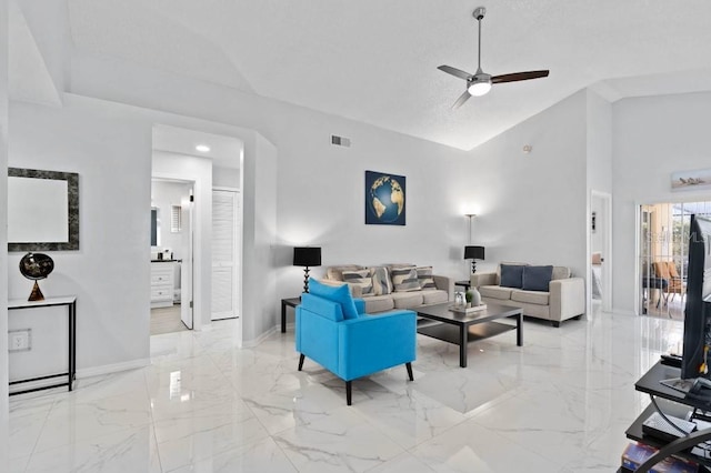 living room with ceiling fan and high vaulted ceiling