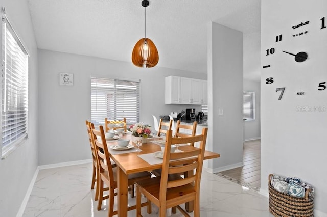 dining area with a textured ceiling