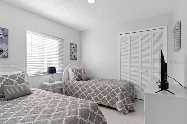 bedroom with a closet and a textured ceiling