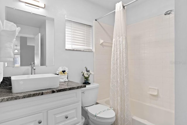 full bathroom with vanity, toilet, and shower / tub combo