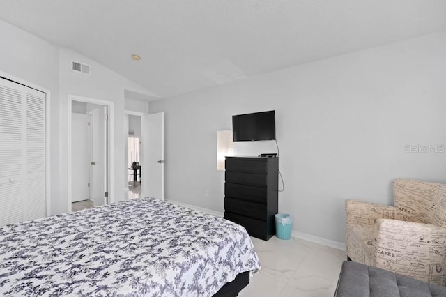 bedroom featuring a closet and vaulted ceiling