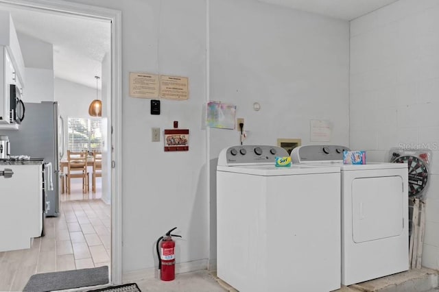 laundry room with independent washer and dryer