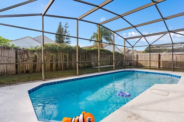 view of swimming pool featuring a patio and glass enclosure