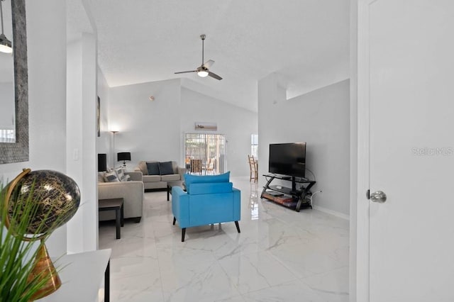 living room with ceiling fan and high vaulted ceiling