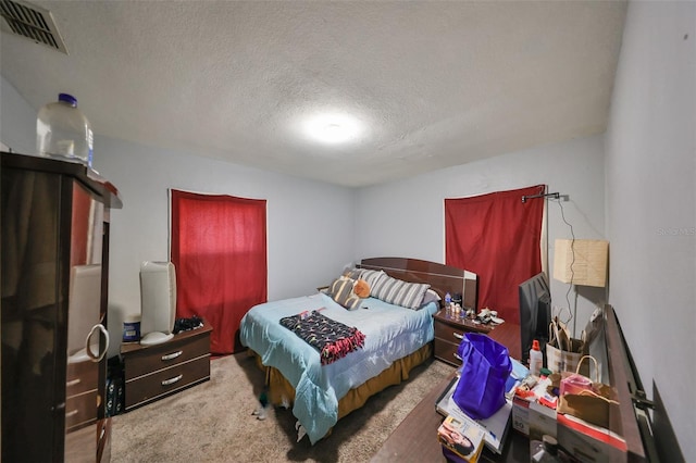 carpeted bedroom with a textured ceiling