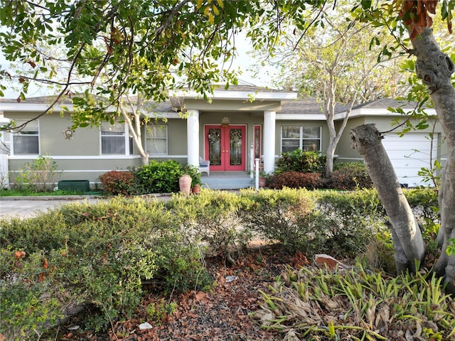 view of front of property featuring stucco siding and french doors