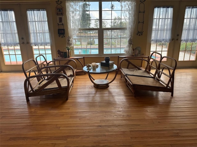 dining area with a wealth of natural light, hardwood / wood-style floors, and french doors