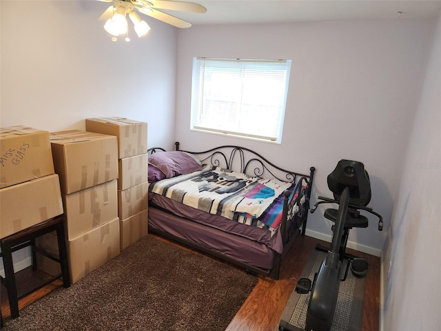 bedroom with ceiling fan and dark hardwood / wood-style floors