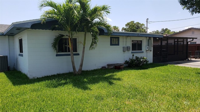 exterior space with cooling unit and a yard