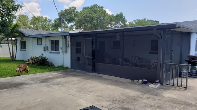 back of property featuring a sunroom