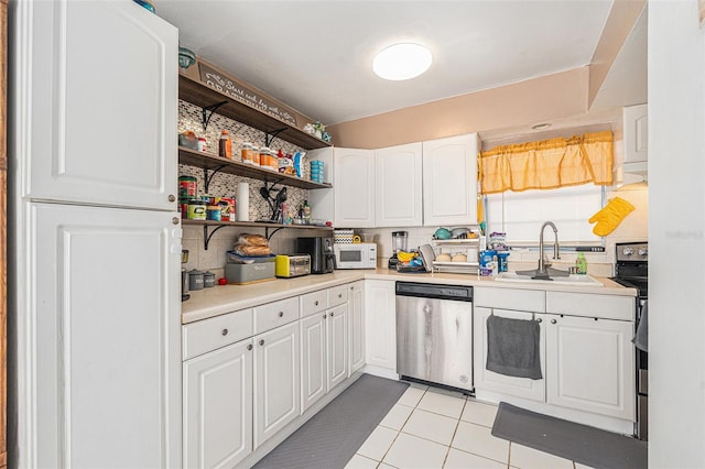 kitchen featuring dishwasher, backsplash, white cabinets, sink, and light tile patterned floors