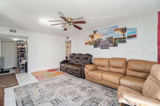 tiled living room featuring ceiling fan and a textured ceiling