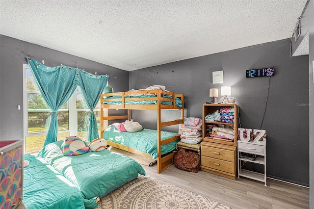 bedroom featuring a textured ceiling and hardwood / wood-style flooring