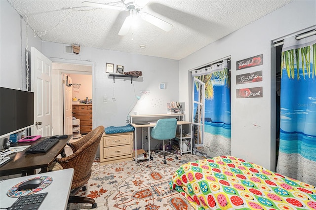 office space with a textured ceiling and ceiling fan