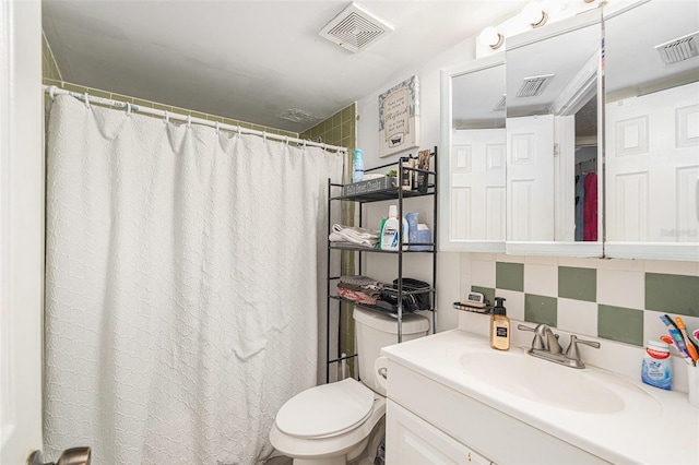 bathroom featuring decorative backsplash, vanity, and toilet