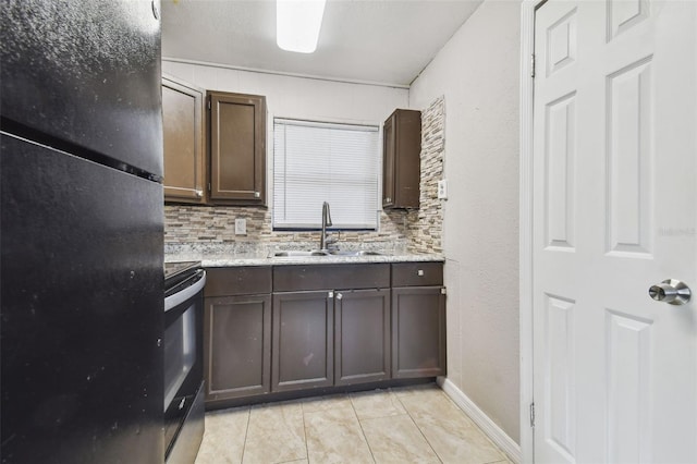 kitchen with black appliances, sink, decorative backsplash, light tile patterned floors, and dark brown cabinets