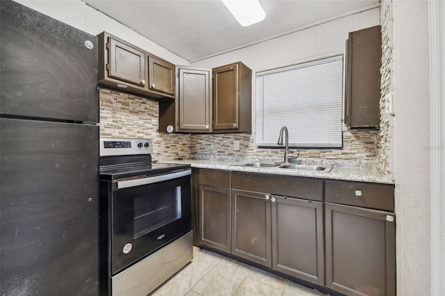 kitchen with stainless steel electric range, black fridge, sink, tasteful backsplash, and dark brown cabinets