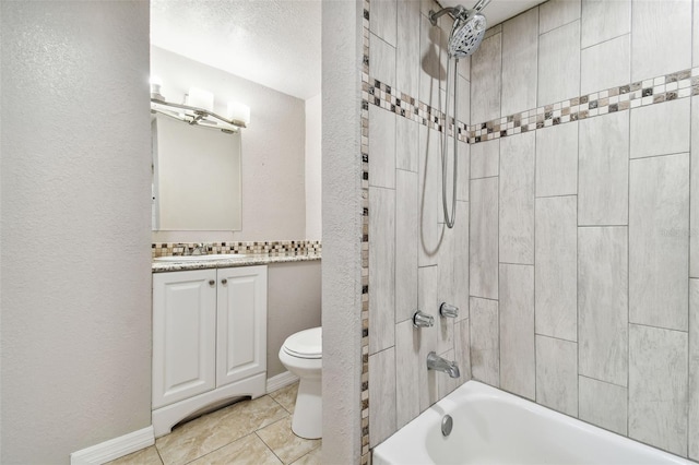 full bathroom featuring toilet, vanity, tiled shower / bath combo, and tile patterned floors