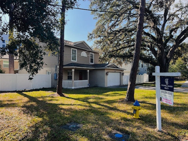 view of front of property featuring a garage and a front yard