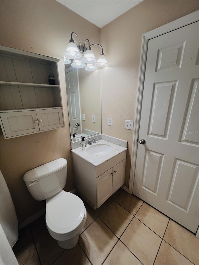 bathroom featuring vanity, toilet, and tile patterned flooring