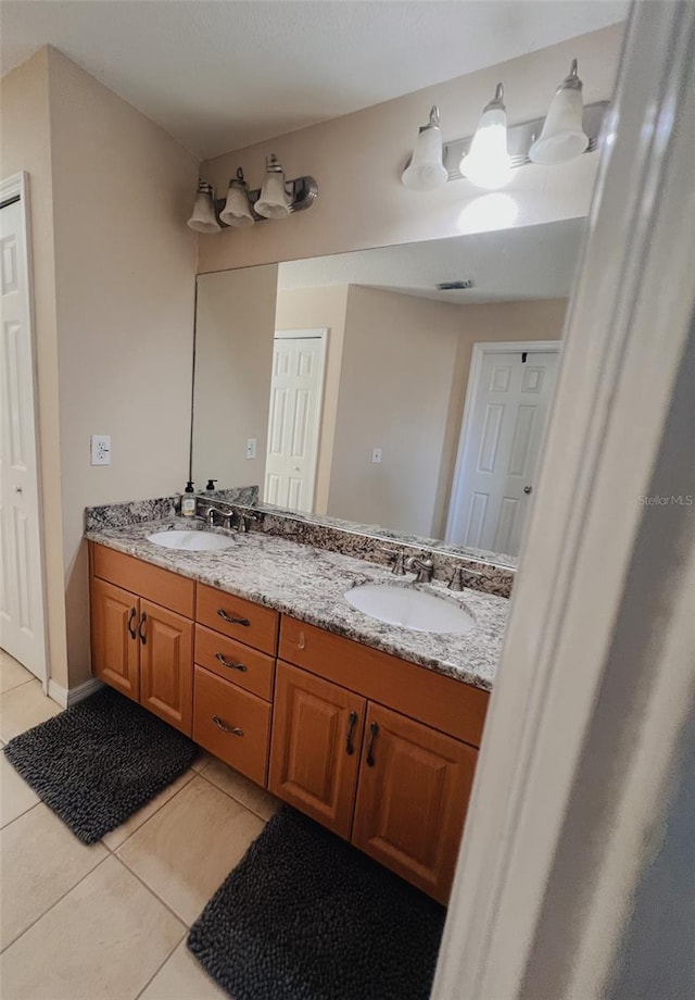 bathroom with tile patterned flooring and vanity