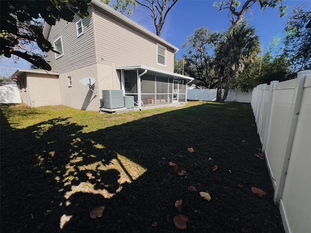 view of yard with cooling unit, a sunroom, and a fenced backyard