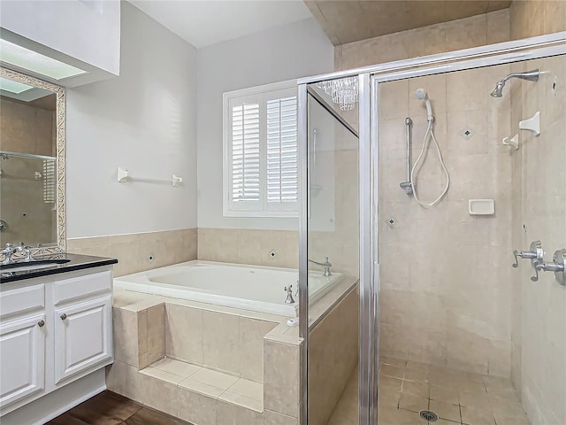 bathroom featuring plus walk in shower and vanity