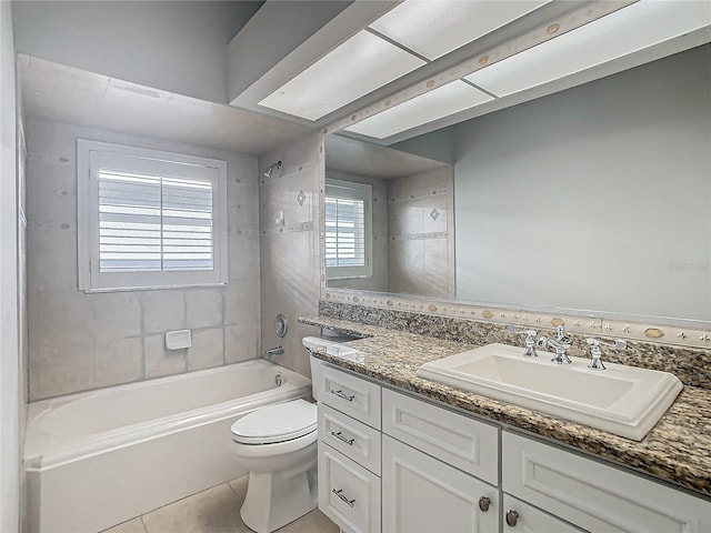 full bathroom featuring tile patterned flooring, vanity, toilet, and tiled shower / bath combo