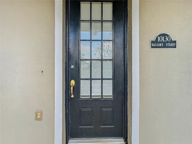 10130 Balcony St, New Port Richey, FL 34655 - property entrance featuring stucco siding