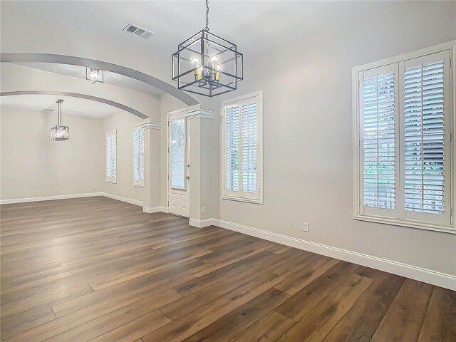 entryway featuring a notable chandelier and dark wood-type flooring