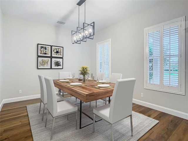 10130 Balcony St, New Port Richey, FL 34655 - dining room with plenty of natural light, dark wood finished floors, and baseboards