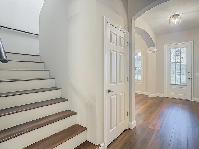 10130 Balcony St, New Port Richey, FL 34655 - entryway featuring arched walkways, dark wood-type flooring, stairway, and baseboards