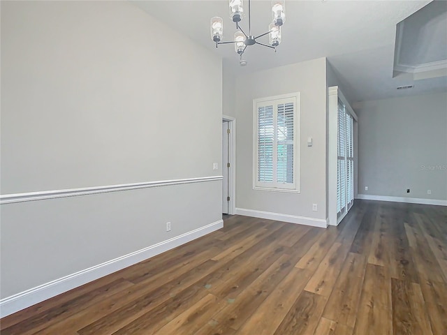 interior space featuring dark hardwood / wood-style flooring and an inviting chandelier