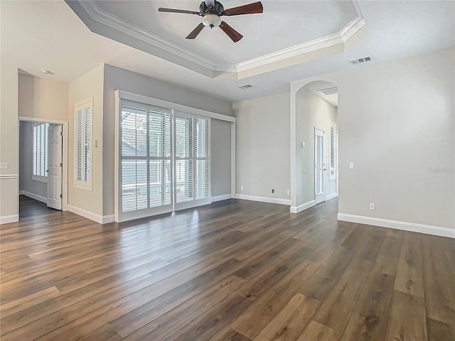 10130 Balcony St, New Port Richey, FL 34655 - unfurnished room with a raised ceiling, arched walkways, a ceiling fan, dark wood-style floors, and crown molding