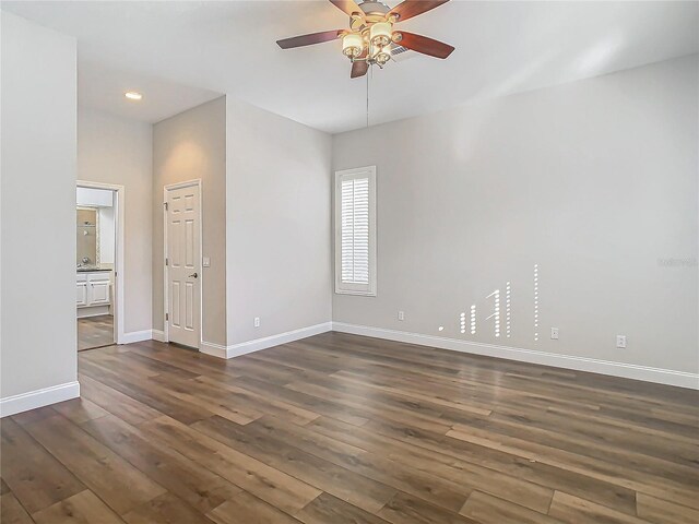 unfurnished room with ceiling fan and dark hardwood / wood-style flooring