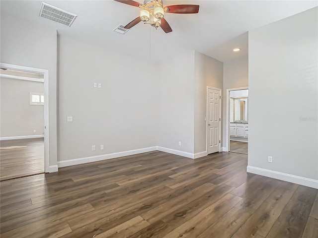 spare room with ceiling fan and dark hardwood / wood-style flooring