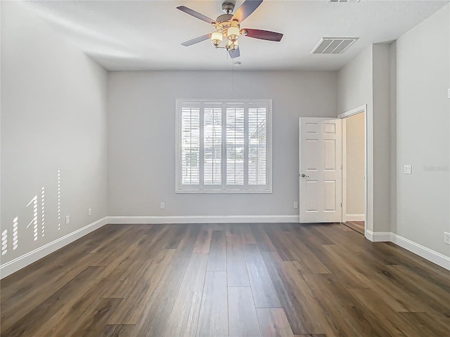 spare room with ceiling fan and dark hardwood / wood-style flooring