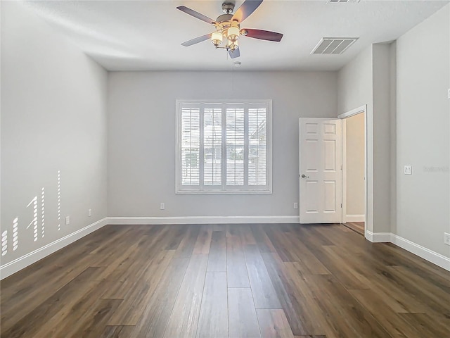 10130 Balcony St, New Port Richey, FL 34655 - empty room featuring a ceiling fan, dark wood-style floors, and baseboards