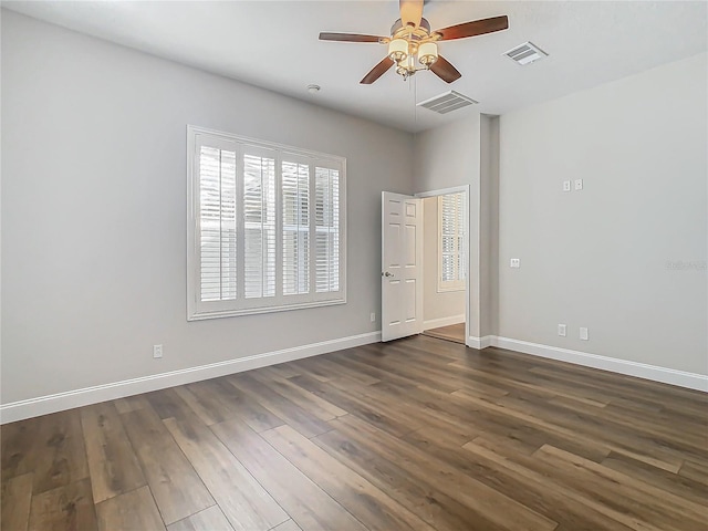 unfurnished room featuring dark hardwood / wood-style floors and ceiling fan