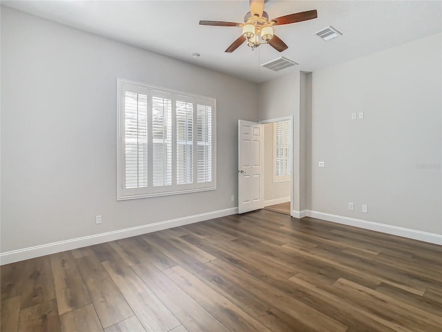 10130 Balcony St, New Port Richey, FL 34655 - unfurnished bedroom with dark wood-style flooring, baseboards, and ceiling fan
