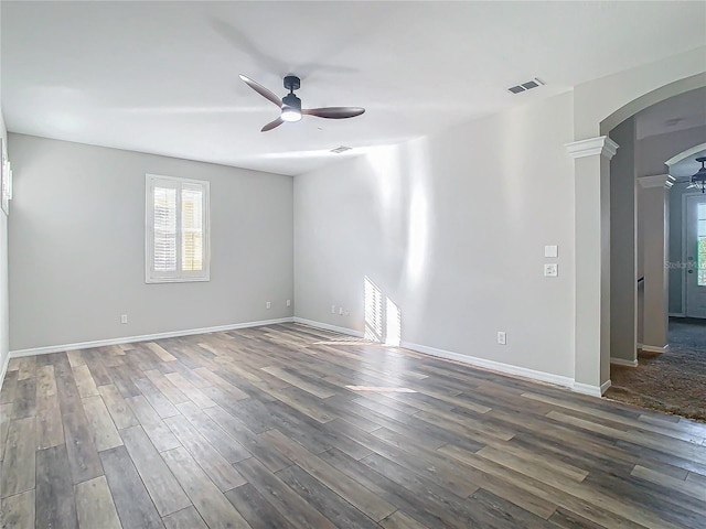 10130 Balcony St, New Port Richey, FL 34655 - unfurnished room featuring ceiling fan, arched walkways, dark wood-style floors, and baseboards