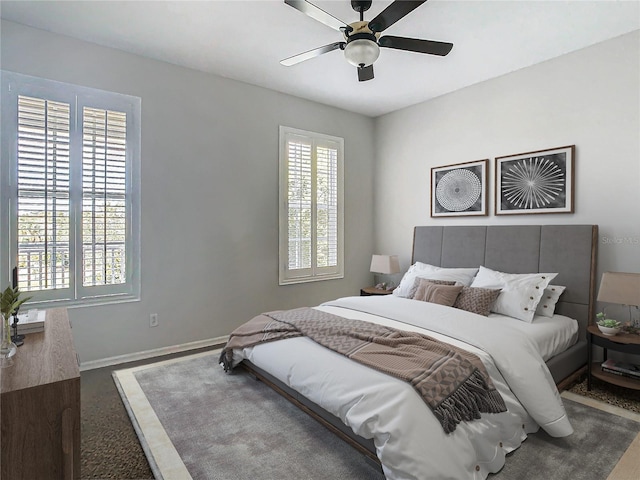 bedroom featuring multiple windows and ceiling fan