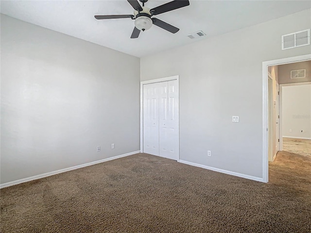 unfurnished bedroom with ceiling fan, a closet, and carpet