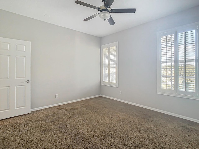 empty room featuring carpet floors and ceiling fan