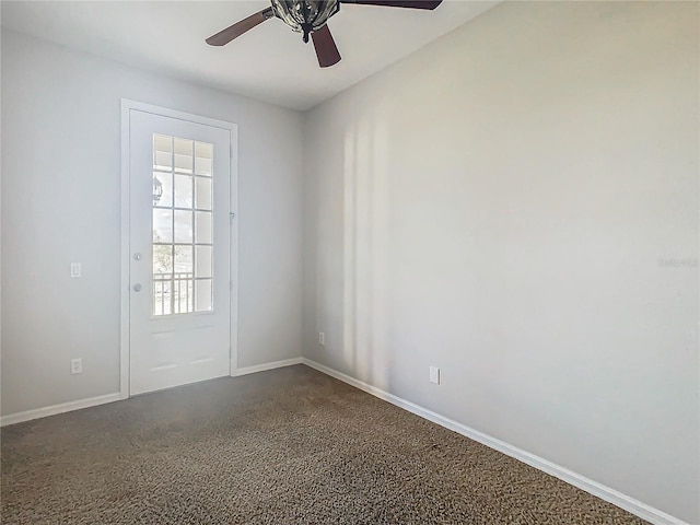 doorway to outside featuring dark colored carpet and ceiling fan