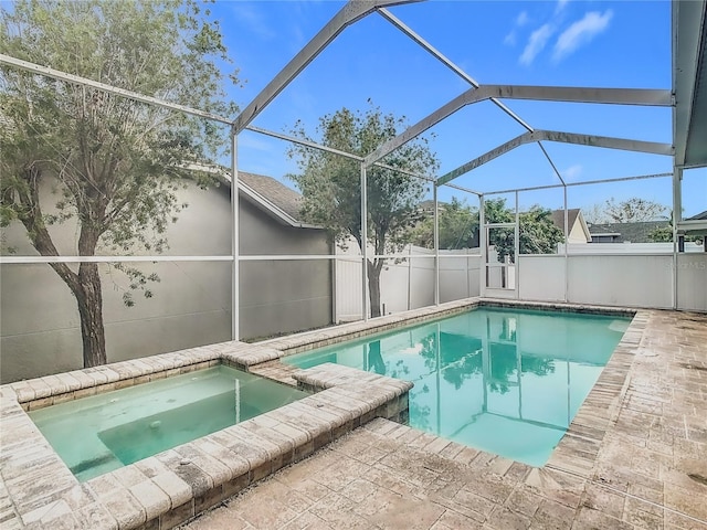 view of swimming pool with an in ground hot tub and glass enclosure