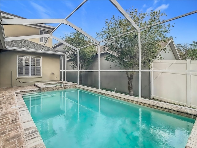 view of pool with an in ground hot tub, a patio area, and a lanai