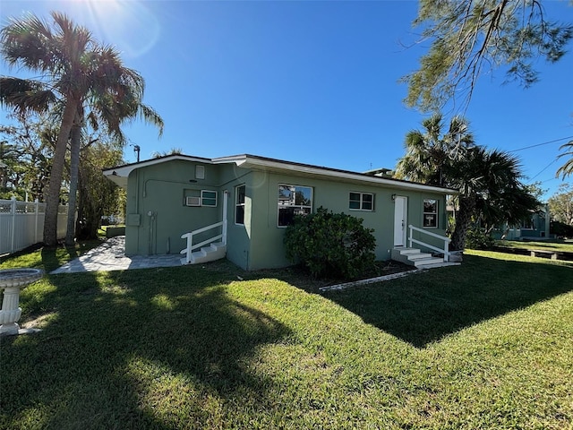 rear view of property featuring a yard