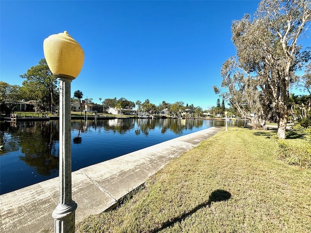 dock area featuring a water view and a yard