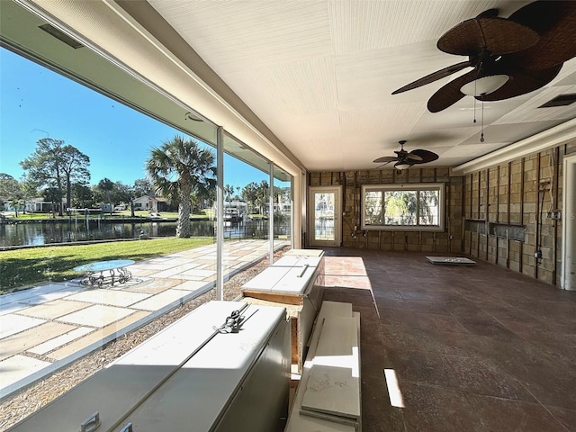 view of patio / terrace featuring a water view, ceiling fan, and exterior bar